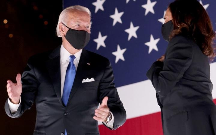 Democratic presidential nominee Joe Biden and Democratic Vice Presidential nominee Kamala Harris confer on stage outside the Chase Center after Biden delivered his acceptance speech in Wilmington, Delaware. 