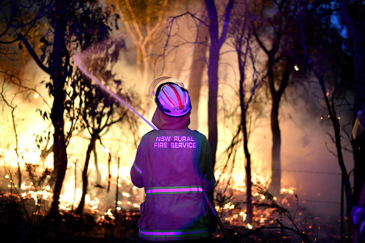  A firefighter protecting a residential area from bushfires north of Sydney on 7 December, 2019. Experts said the last Australian bushfire season arrived earlier and with more intensity because of climatic changes and prolonged drought. 