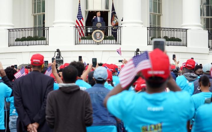 US President Donald Trump speak about law and order to supporters from the South Portico of the White House in Washington, DC, on October 10, 2020. - 