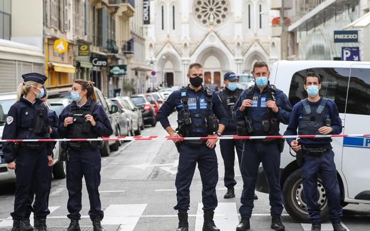 Police block the access to the Notre-Dame de l'Assomption Basilica in Nice on October 29, 2020 after a knife-wielding man kills three people at the church, 