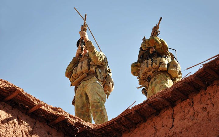 Australian soldiers from the Special Operations Task Group using their rifle scopes to investigate the surrounding mountains during an operation in southern Afghanistan on October 21, 2009.