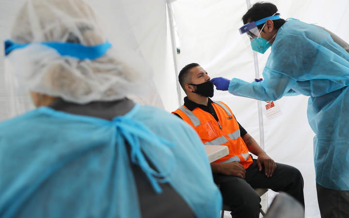 Jose Deloera is tested for COVID-19 at a testing site provided by the International Brotherhood of Teamsters on July 16, 2020 in Long Beach, California.