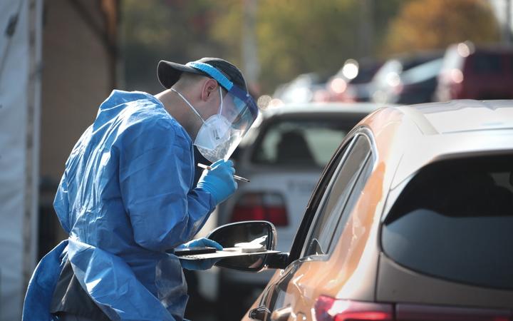 MILWAUKEE, WISCONSIN - OCTOBER 09: Members of the Wisconsin National Guard test residents for the coronavirus COVID-19 at a temporary test facility set up in the parking lot of the UMOS corporate headquarters on October 09, 2020 in Milwaukee, Wisconsin. 