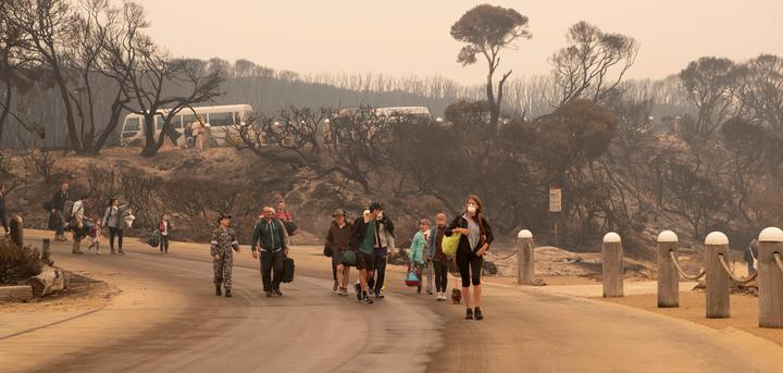 Evacuees walking to the beach to board a navy ship to escape fires at Mallacoota, Victoria, on 3 January 2020. 