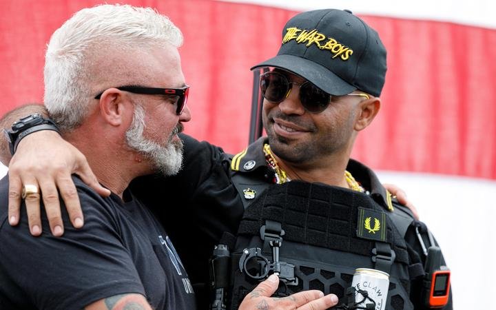 Leaders of the Proud Boys, a right-wing pro-Trump group, Enrique Tarrio (right) and Joe Biggs (left) embrace each other as the Proud boys members gather with their allies in a rally called "End Domestic Terrorism" against Antifa in Portland, Oregon on 26 September, 2020.