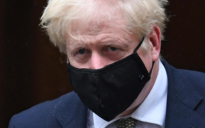 Britain's Prime Minister Boris Johnson wearing a face mask leaves 10 Downing Street ion October 12, 2020 headed for the House of Commons, where he is set to announce a new Covid-19 alert system.