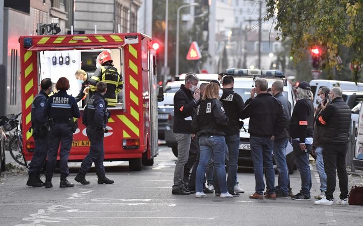 Security and emergency personnel are on October 31, 2020 in Lyon at the scene where an attacker armed with a sawn-off shotgun wounded an Orthodox priest in a shooting before fleeing, said a police source. 