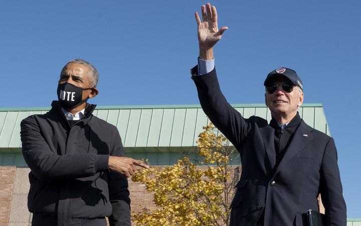 Former US President Barack Obama (L) joins Democratic presidential candidate Joe Biden at a campaign event in Flint, Michigan, on October 31, 2020. 