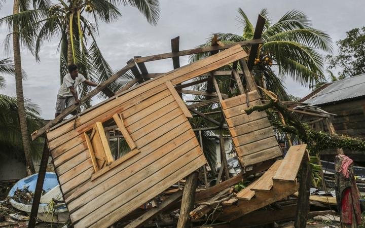 Men fix a small house in "El Muelle" Neighbourhood in Bilwi, Nicaragua on November 5, 2020, after the passage of hurricane Eta. 