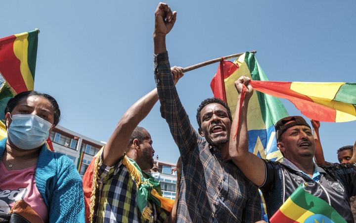 People carry Amhara flags and Ethiopia national flags in the streets after a national call to stand in honour of the Ethiopian National Defence Forces, in Addis Ababa, on November 17, 2020.