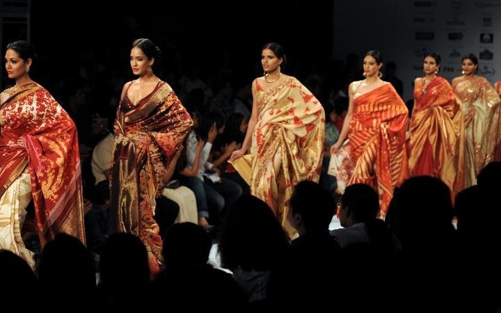 (FILES) In this file photo taken on September 12, 2009 models display creations by designer Satya Paul during the Kolkata Fashion Week II in Kolkata. - 