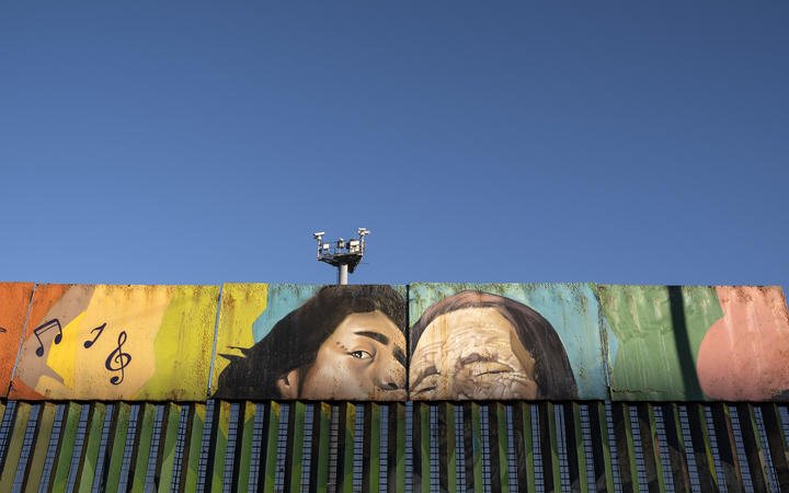 Paintings on the US-Mexico border at the Friendship Park seen from Baja California state in Mexico on January 16, 2021.
