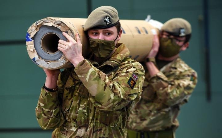 Members of the Royal Scots Dragoon Guards, all wearing face coverings, work to convert a sports hall into a Covid 19 vaccination centre at the Donald Dewar Centre in Glasgow, on January 20, 2021. 