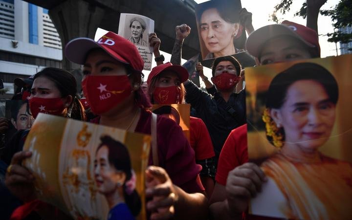 Myanmar migrants hold up portraits of Aung San Suu Kyi as they demonstrae outside the Myanmar embassy in Bangkok on 1 February 2021, over the military coup in Myanmar.