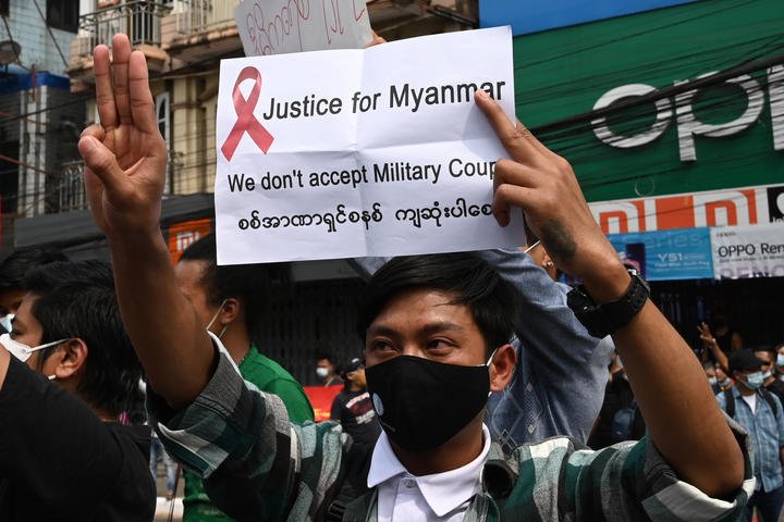 A protester in Yangon flashes the three-finger salute, which has become a symbol of defiance in the region.